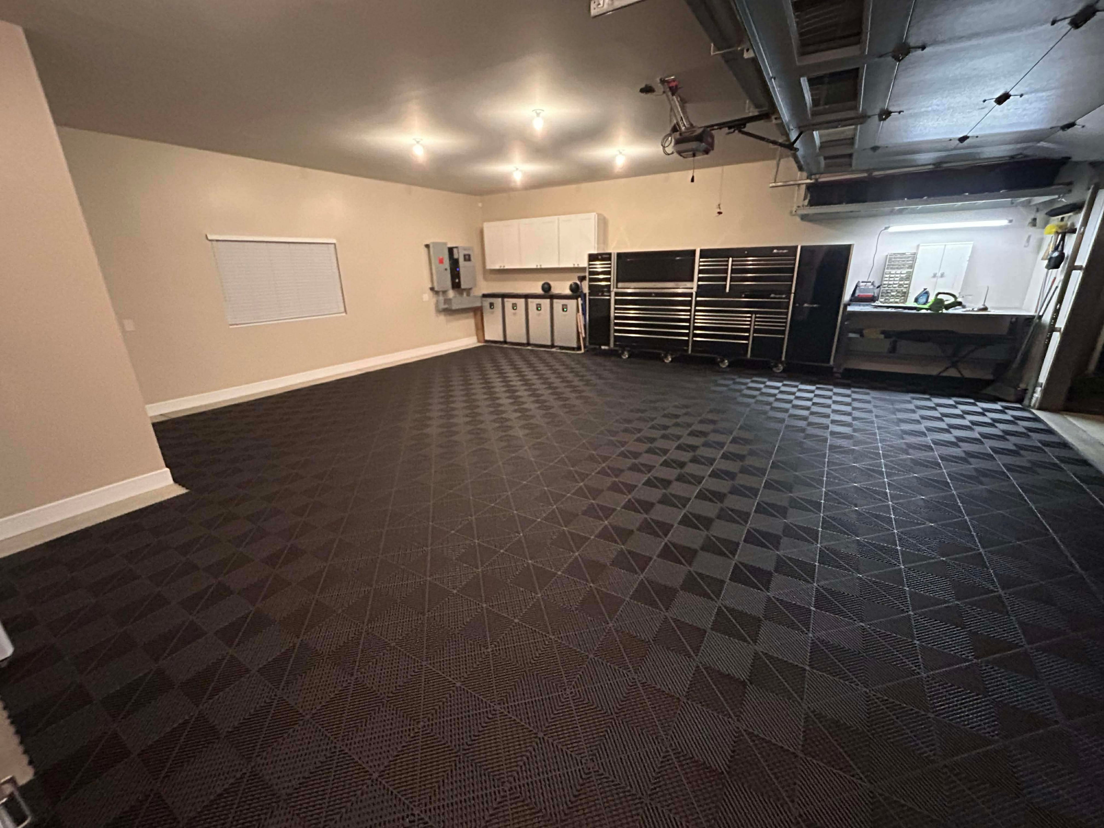 Basement with black diamond-patterned floor, white walls, and various equipment.
